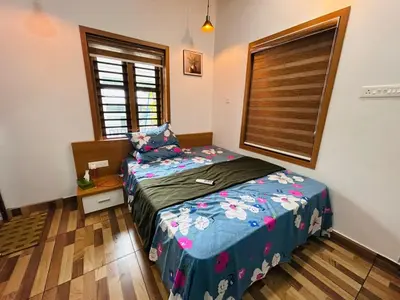 a small bedroom with a bed and a window at Vayalil Homestay in Karuvārakundu