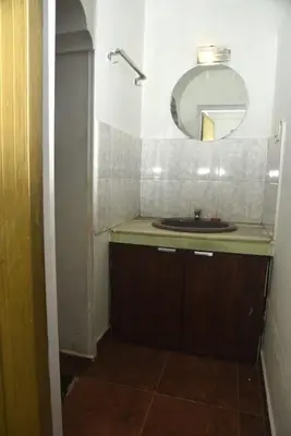 a bathroom with a sink and a mirror at Mountain Villa Ooty Rooms in Ooty