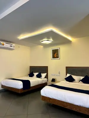 two beds in a hotel room with two bedsvisor at Pakalakam Resorts in Cheruppulasseri