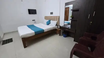 a hotel room with a bed and a mirror at Cozy retreat in Mysore