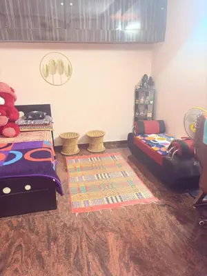 a childs bedroom with a bed and a couch at Lakshminarayanappa Niwasa in Channapatna