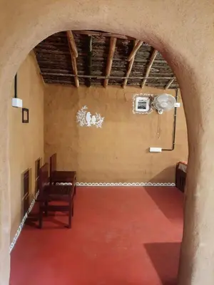 an empty room with a chair and a fan at Mannora Resorts Marayoor in Marayoor