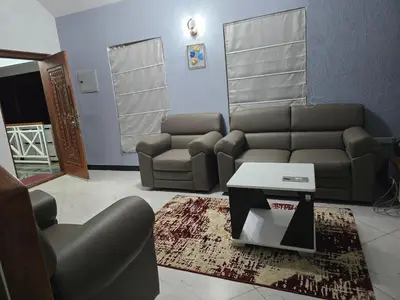 a living room with a couch and a table at Nest Resort in Ketti