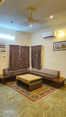 a living room with a bed and a couch at JEO Home Stay And Hospitality in Mysore