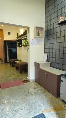 a kitchen with a counter and benches in a room at JEO Home Stay And Hospitality in Mysore