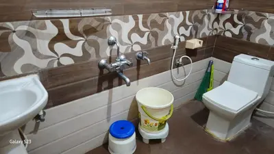 a bathroom with a toilet and a sink at JEO Home Stay And Hospitality in Mysore