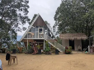 a house with a horse standing in front of it at Ashokavanam Heritage Village by N Square in Kanthalloor