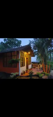 a small house with a patio in front of it at Tribal land homestay in Kushālnagar