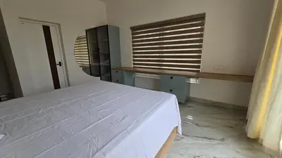 a bedroom with a white bed and a window at Casa Bella - The Group Stay in Sultan Bathery