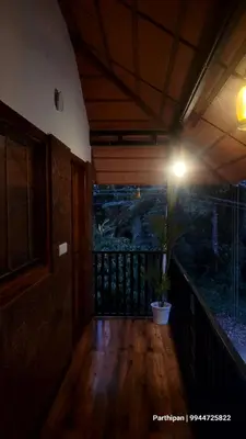 a room with a potted plant on a balcony at Heaven Crest Holidays and Plantations in Chithragiri