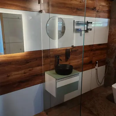 a bathroom with a sink and a mirror at Heaven Crest Holidays and Plantations in Chithragiri