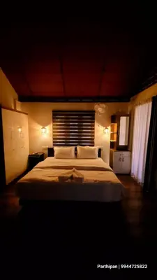 a bedroom with a large bed in a room at Heaven Crest Holidays and Plantations in Chithragiri