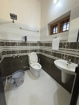 a bathroom with a toilet and a sink at Keshavam Homestay in Guruvāyūr