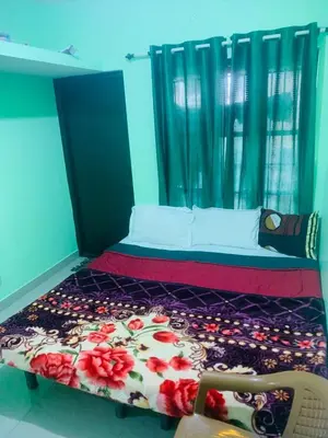 a bedroom with a bed and a chair in it at Nature View Private Villa in Ooty