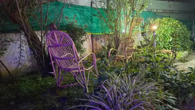 two purple chairs sitting in a garden at Nature View Private Villa in Ooty
