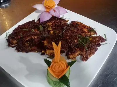 a plate of food with flowers on a table at AE Tower Platinum Retreat in Sultan Bathery