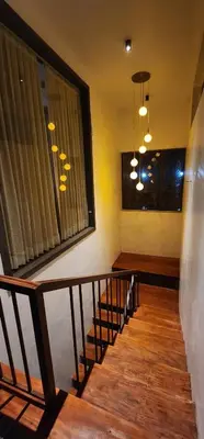 a hallway with a staircase with a window and a stair railing at Itria private pool villa in Pinangode