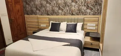a bedroom with a large bed with a wooden headboard at Itria private pool villa in Pinangode
