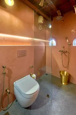 a bathroom with a toilet and a shower at Seclude Karthika Nivas, Thrissur in Trichūr