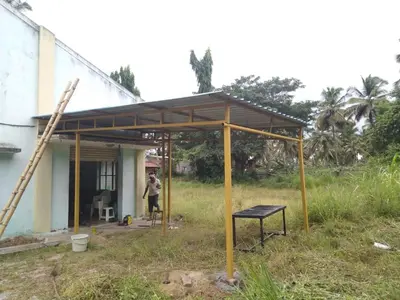 a house being constructed with a metal roof at NKM Holiday Park in Shrīrangapattana