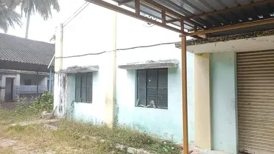 a blue and white building with a window and a gate at NKM Holiday Park in Shrīrangapattana