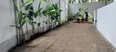 a person standing next to a wall with plants at Little home Apartment 1 in Tāzhekkod