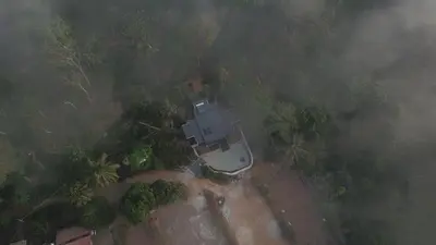 an aerial view of a house in a forest at Trumpet Deck 3BHK Container Home in Kutta