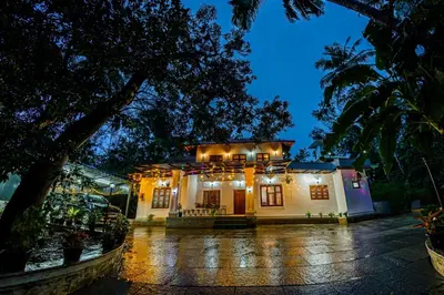 a house with lights on it at night at vintage inn in Kommeri
