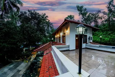 a house with a street light on a walkway at vintage inn in Kommeri