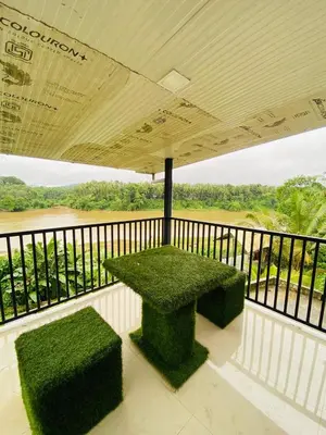 a table on a balcony with a view of a river at Verito Home Stay