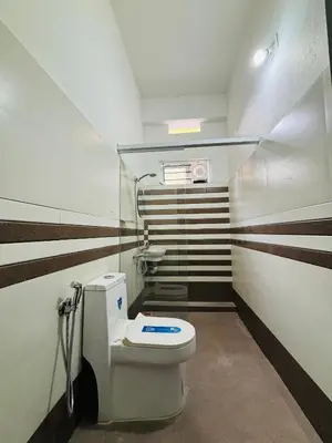 a small bathroom with a toilet and a sink at Verito Home Stay