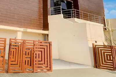 a building with a wooden gate and a balcony at Super Collection O Avarampalayam Bus Stop Formerly Krish Castle in Coimbatore