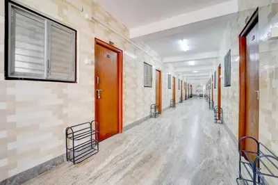 a hallway of a hospital with wooden doors and tile walls at Super Collection O Avarampalayam Bus Stop Formerly Krish Castle in Coimbatore