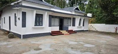 a house with a courtyard in front of it at The Coffee Cube in Kaniyāmbetta