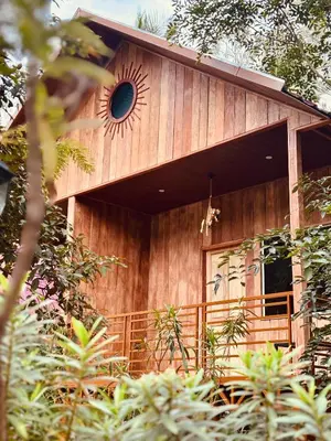 a wooden house with a sun window on it at FAMILY RESORT MARAYOoR KANTHALLOOR in Kanthalloor