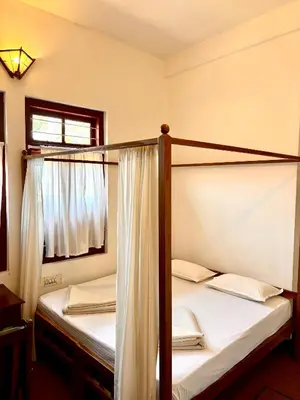 two bunk beds in a room with a window at FAMILY RESORT MARAYOoR KANTHALLOOR in Kanthalloor