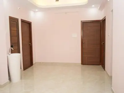 a hallway with two wooden doors and a tile floor at Serene Legacy in Mysore