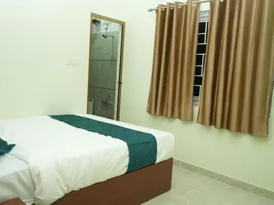 a bedroom with a bed and a window at Serene Legacy in Mysore