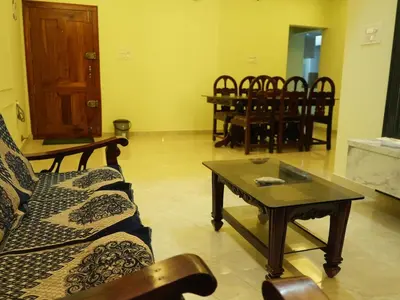 a living room with a couch and a coffee table at Serene Legacy in Mysore