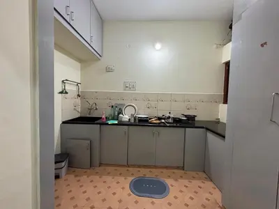 a kitchen with a sink and a counter top at Sihi-2 bhk Non AC and Penthouse AC Rooms in Mysore