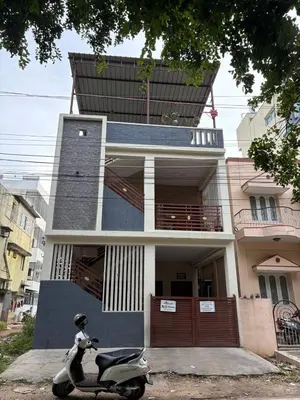 a scooter parked in front of a house at Sihi-2 bhk Non AC and Penthouse AC Rooms in Mysore