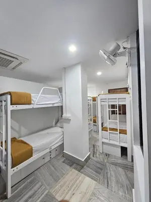 a bunk bed room with two bunk beds at Lowfare Dormitory in Kozhikode