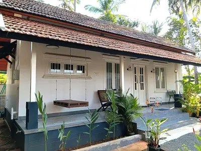 a cottage in a resort with a porch at Private 1BHK Kerala Village Homestay with Open Veranda near Thrissur in Cheruthuruthi