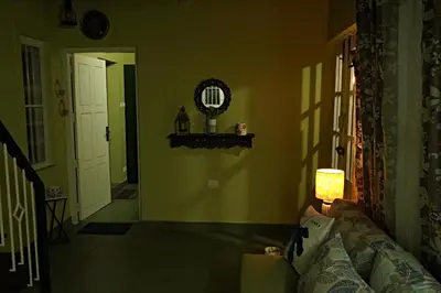 a living room with a couch and a lamp at Private 1BHK Kerala Village Homestay with Open Veranda near Thrissur in Cheruthuruthi