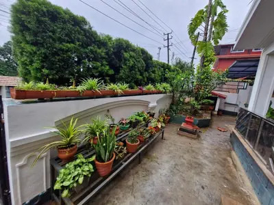 a balcony with potted plants on a building at Coorg Coffee Tales in Suntikoppa