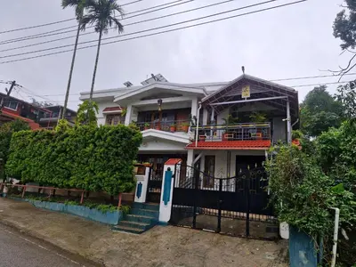 a house with a gate in front of it at Coorg Coffee Tales in Suntikoppa
