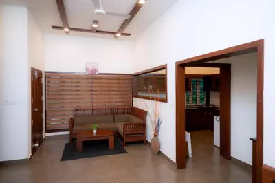 a living room with a couch and a table at Thiraa Inn Nilambur By Hotelbuz in Nilambūr