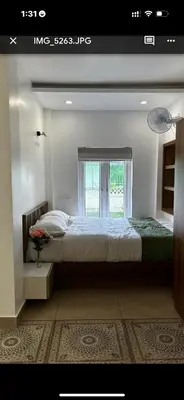 a bedroom with a large bed and a window at Heaven-Vadanapilly Beach Villa in Irimbranallūr
