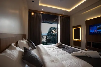 a bedroom with a large bed with a large window at Lake Paradise Resort in Padinjarathara