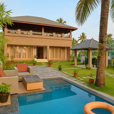 a house with a swimming pool in front of a house at Cherai Beach Regency in Ernakulam